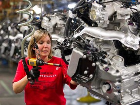 In this file photo, Engine Specialist Jennifer Souch assembles a Camaro engine at the GM factory in Oshawa, Ontario on Friday, June 10, 2011.