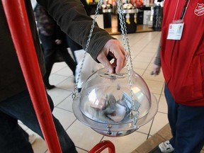 In this file photo, a shopper makes a donation into one of the Salvation Army kettles at the Devonshire Mall in Windsor in 2011. (Windsor Star files)
