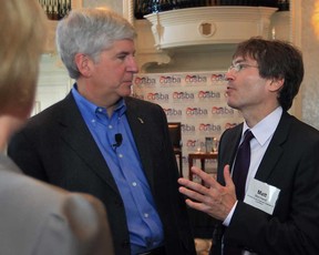 Gov. Rick Snyder, left,) speaks with Matt Marchand, president and CEO of the Windsor-Essex Regional Chamber of Commerce, at a town hall meeting Monday, Oct. 22, 2012,  in Detroit sponsored by the Canada United States Business Association. Snyder encouraged business leaders to support the Detroit River International Crossing project.