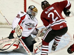 Windsor's Jaroslav Pavelka, left, makes a save on Guelph's Brock McGinn at the WFCU Centre Thursday. (TYLER BROWNBRIDGE/The Windsor Star)