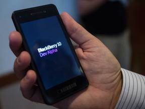 In this file photo, an attendee at the Blackberry 10 Jam World Tour holds one of the company's DevAlpha devices at their stop in Waterloo, Ontario, Thursday, August 23, 2012. (THE CANADIAN PRESS/ Geoff Robins)