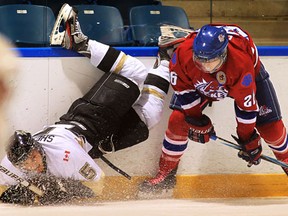 LaSalle's Chad Shepley, left, is checked by Strathroy's Brett Dyck at the Vollmer Centre in LaSalle. (DAN JANISSE/The Windsor Star)
