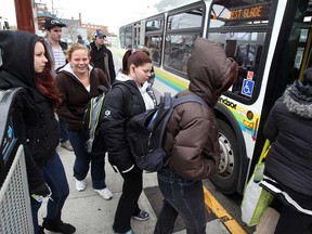 Transit Windsor riders Shawna Billings-Rivait, left, and Kelsey Wiley, 2nd left, join with other riders boarding Transit Windsor 1C at Windsor International Bus Terminal October 31, 2012.  (NICK BRANCACCIO/The Windsor Star)