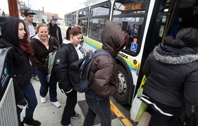 Transit Windsor riders Shawna Billings-Rivait, left, and Kelsey Wiley, 2nd left, join with other riders boarding Transit Windsor 1C at Windsor International Bus Terminal October 31, 2012.  (NICK BRANCACCIO/The Windsor Star)