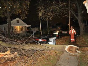 An Enwin worker surveys the damage to hydro wires Monday, Oct. 29, 2012,  in the 800 block of Brant St. in Windsor, Ont. High winds snapped a large tree branch which fell across both lanes of the street forcing police to shut it down to traffic.   (DAN JANISSE/The Windsor Star)
