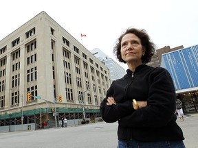 The Paul Martin federal building is seen behind Joan Shanfield in Windsor on Friday, October 5, 2012. Shanfield is upset by the scaffolding that has lined the building for years. (TYLER BROWNBRIDGE / The Windsor Star)