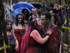 Stacy and  Brian Bellamy exchange a  kiss after a "zombie-themed" wedding at the Devonwood Conservation area in Windsor, Ontario on October 19, 2012.   More than 40 attendees dressed up in detailed zombie costumes to attend the spooky wedding for the horror movie fans who are from Windsor.    (JASON KRYK/ The Windsor Star)