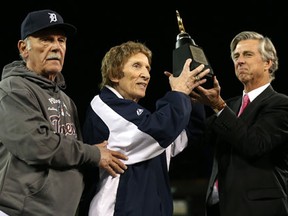 Tigers manager Jim Leyland, from left, team owner Mike Ilitch and general manager Dave Dombrowski celebrate with the American League Championship trophy after the Tigers won 8-1 against the New York Yankees in Game 4 Thursday. (Jonathan Daniel/Getty Images)
