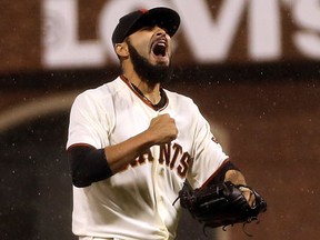 Giants pitcher Sergio Romo celebrates after they beat the Cardinals 9-0 in Game 7 of the National League Championship Series in San Francisco. (Ezra Shaw/Getty Images)