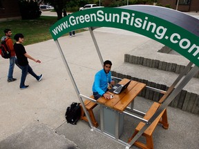 University of Windsor chemistry student Abdullah Allawnha uses GreenSunRising solar recharging station near the Leddy Library Wednesday September 26, 2012. (NICK BRANCACCIO/The Windsor Star)