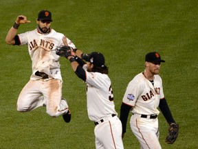 San Francisco's Angel Pagan, from left, Brandon Crawford and Hunter Pence celebrate their 2-0 win against the Detroit Tigers in Game 2 of the World Series. (Thearon W. Henderson/Getty Images)