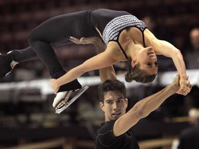 Canadian pairs skaters Paige Lawrence, top, and Rudi Swiegers practise Thursday at the WFCU Centre in Windsor. (DAN JANISSE/The Windsor Star)