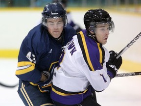 Windsor's Matt Beaudoin, left, is checked by Laurier's Matthew Brown Friday at Windsor Arena. (NICK BRANCACCIO/The Windsor Star)