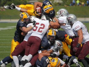 Windsor running back Mitch Dender, top, scores a touchdown against the Ottawa Gee-Gees at Alumni Field. (DAX MELMER/The Windsor Star)