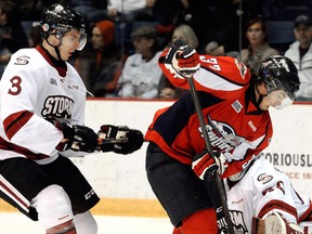 Windsor's Emerson Clark, right, is checked by Guelph's Andrey Pedan during the Spits' 6-4 win in Guelph Friday. (Tony Saxon/Guelph Mercury)