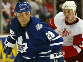Belle River's Tie Domi, left, is checked during a game against the Red Wings at Joe Louis Arena. (Star file photo)