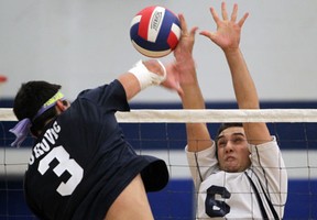 Holy Names' Jon Younan, right, blocks a spike from Massey's Alexander Vukovic during the senior boys volleyball game at Holy Names. (JASON KRYK/The Windsor Star)