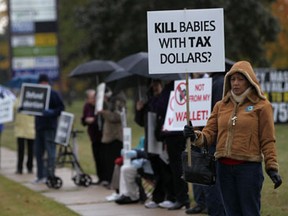 In this file photo, people demonstrate against the funding of abortions while outside the office of MPP Dwight Duncan on Lauzon Parkway Saturday, Oct. 13, 2012.   (DAX MELMER/The Windsor Star)