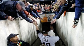 Detroit Tigers' Phil Coke celebrates with fans after his team won Game 4 of the American League championship series, 8-1, against the New York Yankees, Thursday, Oct. 18, 2012, in Detroit. The Tigers move on to the World Series. (AP Photo/Charlie Riedel)