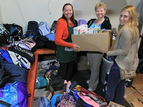 The Street Help Unit 7 organization received a donation of more than 100 backpacks Monday, Oct. 15, 2012, in Windsor, Ont. Laurie Mastronardi (C) and Cassandra Roy (R) of Kingsville, helped collect the backpacks, food and supplies that were donated to Christine Wilson-Furlonger, administrator at the organization. Wilson-Furlonger noted that the backpacks will be handed out immediately to homeless people in the area. The non-profit organization is located in the 900 block of Wyandotte St. East. (DAN JANISSE/ The Windsor Star)