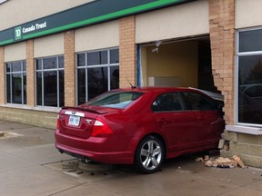 Emergency crews responded to 4115 Walker Road after a car collided into the front window of the TD Canada Trust. (TYLER BROWNBRIDGE/The Windsor Star)