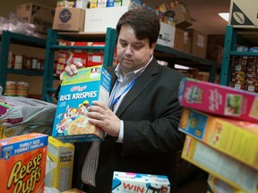 Ron Dunn, director, development and community relations at the Downtown Mission, sorts through donated boxes of cereal, Saturday, Oct. 6, 2012.   (DAX MELMER/The Windsor Star)