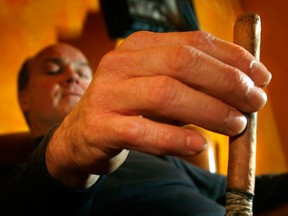 File photo: Warren Fullerton won't  be able to smoke his daily cigar in the tobacco shop's cigar room at  La Casa del Habano  on Ouellette avenue when the smoking ban kicks in on May 31, 2006. (Windsor Star files)