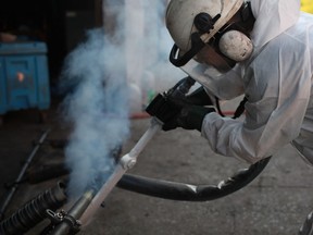 Reid La Flair, owner of Co2Sweep, cleans an old conveyor belt with a dry ice blaster at The Windsor Star office in downtown Windsor, Saturday, Sept. 29, 2012 . (DAX MELMER/The Windsor Star)