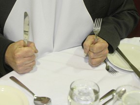File photo of a man waiting to eat at a restaurant. (Postmedia News files)