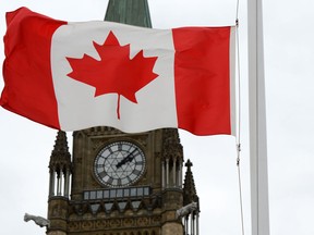 A Canadian flag blows in front of the Peace Tower on Parliament Hill in Ottawa, Ont., Wednesday, Oct. 24, 2012. (THE CANADIAN PRESS/Sean Kilpatrick)