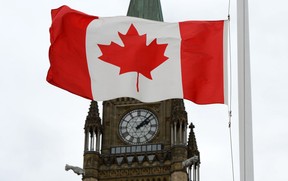 A Canadian flag blows in front of the Peace Tower on Parliament Hill in Ottawa, Ont., Wednesday, Oct. 24, 2012. (THE CANADIAN PRESS/Sean Kilpatrick)
