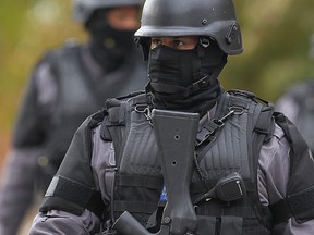 A member of the police tactical team on the scene of a suspected gun call in west Windsor on Oct. 19, 2012. (TYLER BROWNBRIDGE / The Windsor Star)