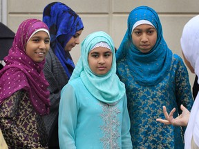 The local Muslim community was participating in the annual Eid al-Adha observance Friday, Oct. 26, 2012, in Windsor, Ont. It is one of IslamÕs two most significant holidays. Here young ladies gather during the event.  (DAN JANISSE/The Windsor Star)