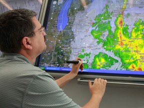 Roger Bastien, a system control operator at Enwin Utilities, monitors a satellite radar in the operations centre showing the path of Hurricane Sandy, on Oct. 29, 2012.  (DAX MELMER/The Windsor Star)
