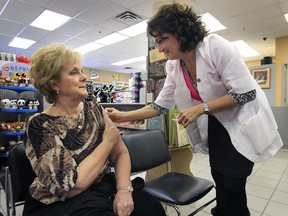 Ziter Pharmacy is the first in the region to get the green light to give flu shots. Pharmacist Christine Ziter gives a shot to Judy Labiak at the Windsor, Ont. pharmacy on Thursday, Oct. 18, 2012.   (DAN JANISSE/ The Windsor Star)