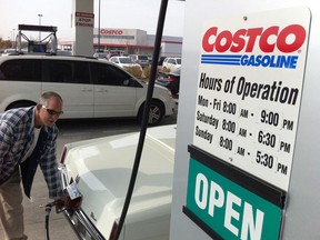 Tim LaRocque fuels up his 1973 Cadillac Eldorado at the Costco gas bar in Windsor, Ont. on Oct. 23, 2012. (Jason Kryk / The Windsor Star)