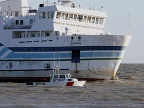 A volunteer auxillary vessel, the Colchester Guardian, passes the Jiimaan after the Pelee Island ferry ran aground in Lake Erie near Kingsville, Ontario on October 11, 2012.  (JASON KRYK/ The Windsor Star)