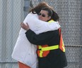 A crew member, right, of the M.V. Jiimaan gets a hug after getting off the ferry in Leamington, Ont. Friday, Oct. 12, 2012. The ferry spent 24 hours stuck on a sandbar near the Kingsville Harbour.The ferry ran aground Thursday while approaching the dock with 34 people aboard. (DAN JANISSE/ The Windsor Star)