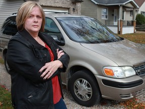 Curbsiding victim Joanne Fox is pictured next to her recently purchased 2001 Chevy Venture LS at her home. Fox bought the vehicle for $3,500 and then, a month later, spent close to $3,000 in repairs, including a new engine. (DAX MELMER / The Windsor Star)