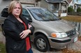 Curbsiding victim Joanne Fox is pictured next to her recently purchased 2001 Chevy Venture LS at her home. Fox bought the vehicle for $3,500 and then, a month later, spent close to $3,000 in repairs, including a new engine. (DAX MELMER / The Windsor Star)