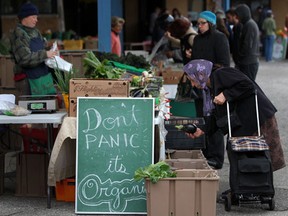 A "Don't panic, it's organic" sign sits among the produce on the last day of the season for the Downtown Farmer's Market in downtown Windsor, Ont., Saturday, Oct. 6, 2012.   (DAX MELMER/The Windsor Star)