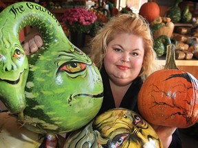 In this file photo, Susan Dupont Baptista poses with some of the pumpkins she paints for the Halloween season. She uses the white pumpkins from Maria's Market in Kingsville, Ont. where she sells the works of art. (DAN JANISSE/ The Windsor Star)