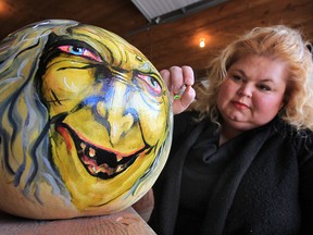 Susan Dupont Baptista paints a pumpkin for the Halloween season. Her creations are for sale at Maria's Market in Kingsville. (DAN JANISSE / The Windsor Star)