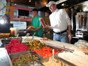 Steve Majed (a.k.a. Shawarma Steve) prepares to drop some sauce on a shawarma sandwich at Shawarma Palace, 276 Ouellette Ave. in Windsor, Ont. Photographed Oct. 31, 2012. (Nick Brancaccio / The Windsor Star)