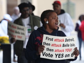 Protesters march in front of a hotel in Detroit, MI. Monday, Oct. 22, 2012, where Gov. Rick Snyder was speaking at a function sponsored by the Canada United States Business Association. Snyder was encouraging business leaders to support the Detroit River International Crossing project. The handful of protesters are against the DRIC project and are supporting the Moroun family's plan to build a second span. (DAN JANISSE/The Windsor Star)