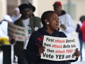 Protesters march in front of a hotel in Detroit, MI. Monday, Oct. 22, 2012, where Gov. Rick Snyder was speaking at a function sponsored by the Canada United States Business Association. Snyder was encouraging business leaders to support the Detroit River International Crossing project. The handful of protesters are against the DRIC project and are supporting the Moroun family's plan to build a second span. (DAN JANISSE/The Windsor Star)