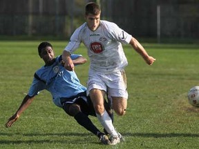 York Region's Daryl Gomez, left, battles Windsor's Chris Suta at Windsor Stadium, Sunday, Oct. 14, 2012. Suta and the Stars dropped their first game of the season in Ontario League One. (DAX MELMER/The Windsor Star)