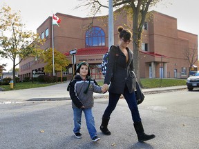 Amanda Armstrong shared her thoughts on teachers being told to write as little as possible on the student report cards as a way to protest the McGuinty work to rule initiative. Her son Alex Charara, 6, attends Dougall Ave. Public School.   (DAN JANISSE/ The Windsor Star)