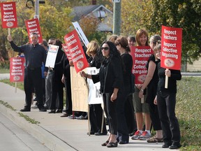 Teachers protest Monday, Oct. 22, 2012, in front of the Dr. David Suzuki Public School in Windsor, Ont. They were voicing their displeasure with Bill 115 that effectively freezes all teacher wages for the next two years . (DAN JANISSE/The Windsor Star)