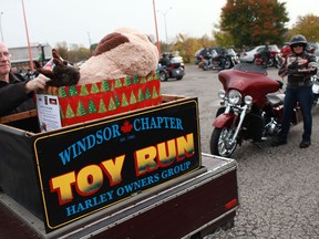Cliff Burack loads donated toys onto a motorcycle trailer at the 24th annual toy drive hosted by the Windsor Homes Coalition Inc. and the Harley Owners Group at Thunder Road Harley-Davidson, Sunday, Oct. 14, 2012.   (DAX MELMER/The Windsor Star)